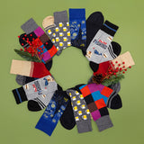 Assorted pairs of socks arranged in a circular pattern on a green background with decorative elements. thumbnail