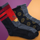 Four pairs of socks with different designs on a two-tone background thumbnail