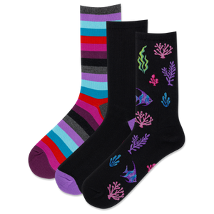 Three pairs of socks inspired by the sea;  one with various pink, red, purple, blue and gray stripes, a solid black crew with a contrast purple toe and one with coral and fish designs on a white background.