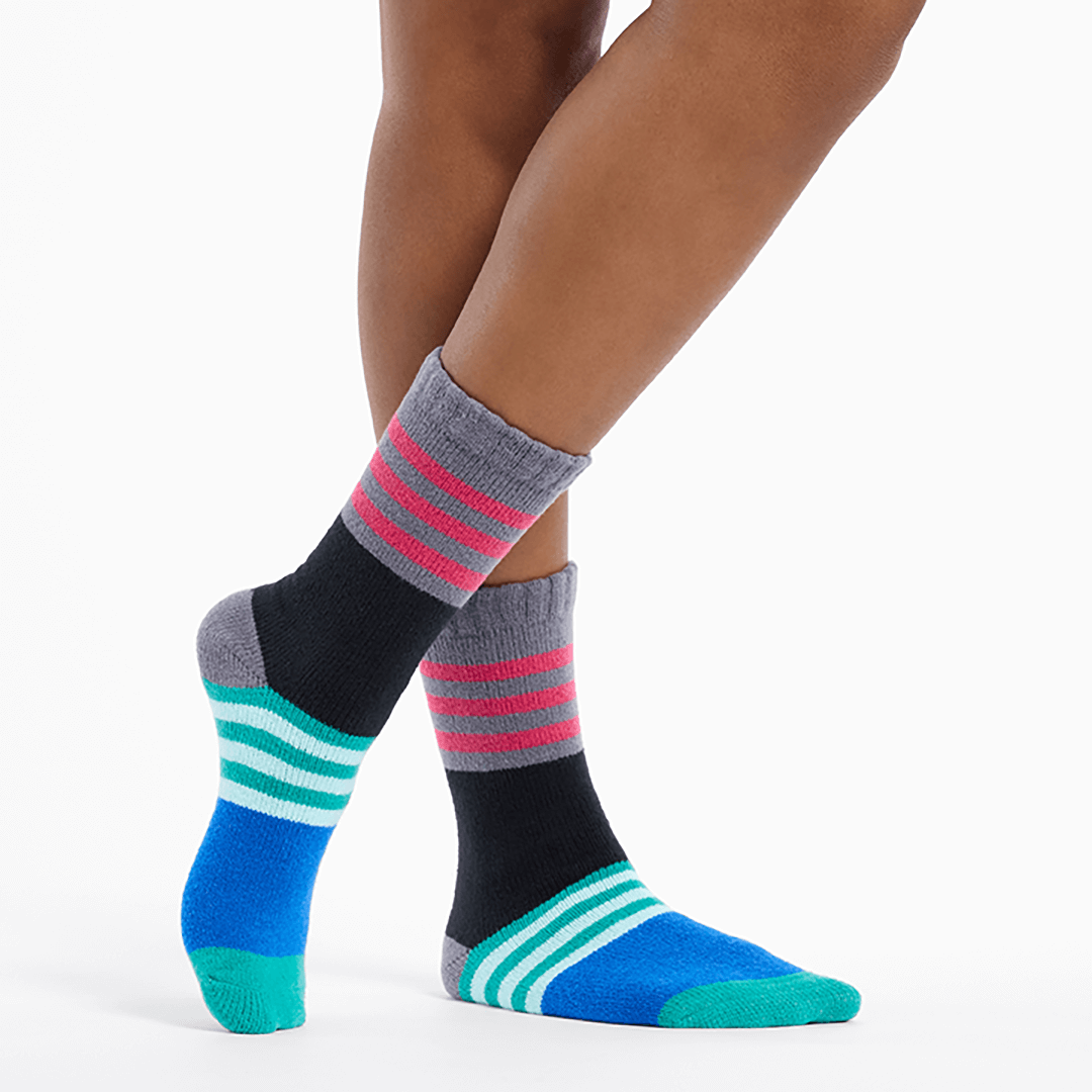 Colorful striped socks worn by a person on a white background