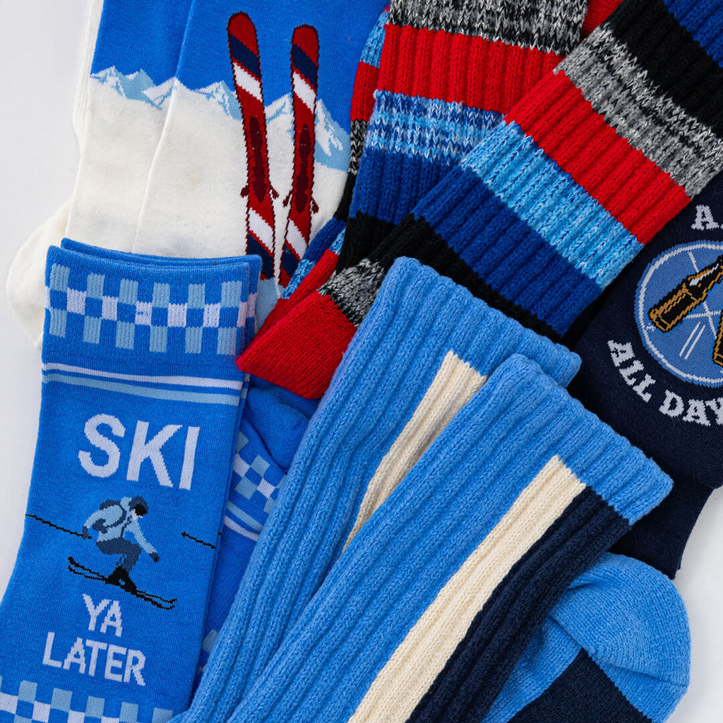 Collection of colorful socks with various designs and text on a white background