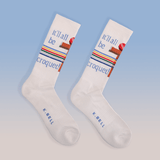 White socks with colorful text and design on a light blue background thumbnail