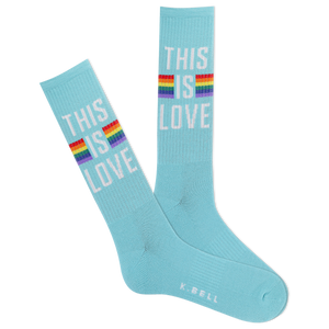 A pair of blue crew socks with a rainbow-colored stripe and the text 'This is love' displayed on the ankle area.