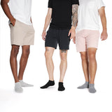 Three men wearing different colored shorts on a white background thumbnail