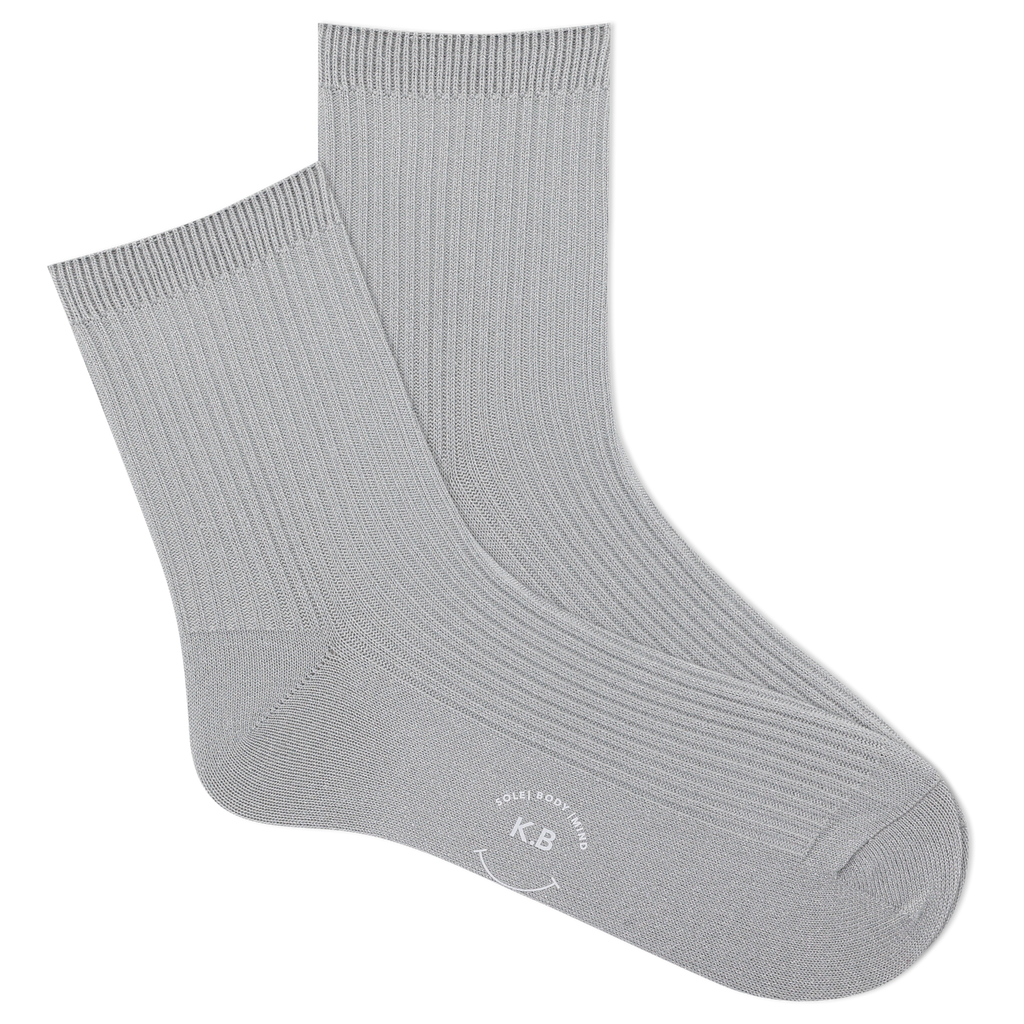 Pair of metallic silver socks on a white background