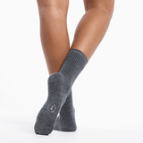 Gray socks worn by a person on a white background thumbnail