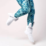 Blue tie-dye leggings worn by a person on a light pink background thumbnail