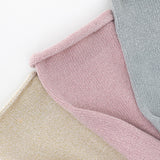 Close-up of textured pink, beige, and gray socks on a white background