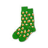 Person wearing black sneakers with green socks featuring beer-themed designs on a wooden floor. thumbnail