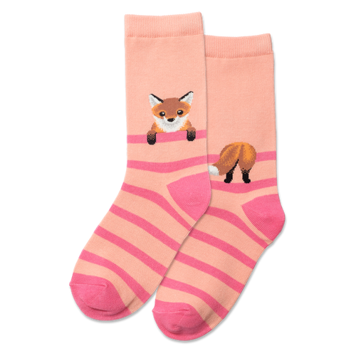 Person wearing pink and beige striped socks with fox designs on a gray floor.