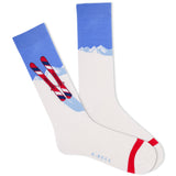 A pair of white crew socks with a blue and red graphic design featuring skis and a mountain range. The brand name 'K.Bell.' thumbnail