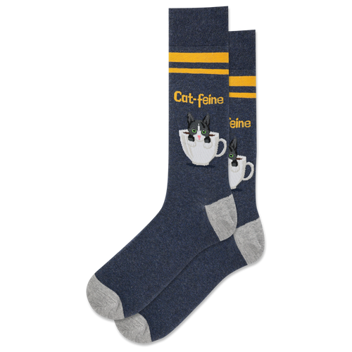 A pair of navy crew socks with a pattern of white cat faces and coffee cups, and yellow stripes.